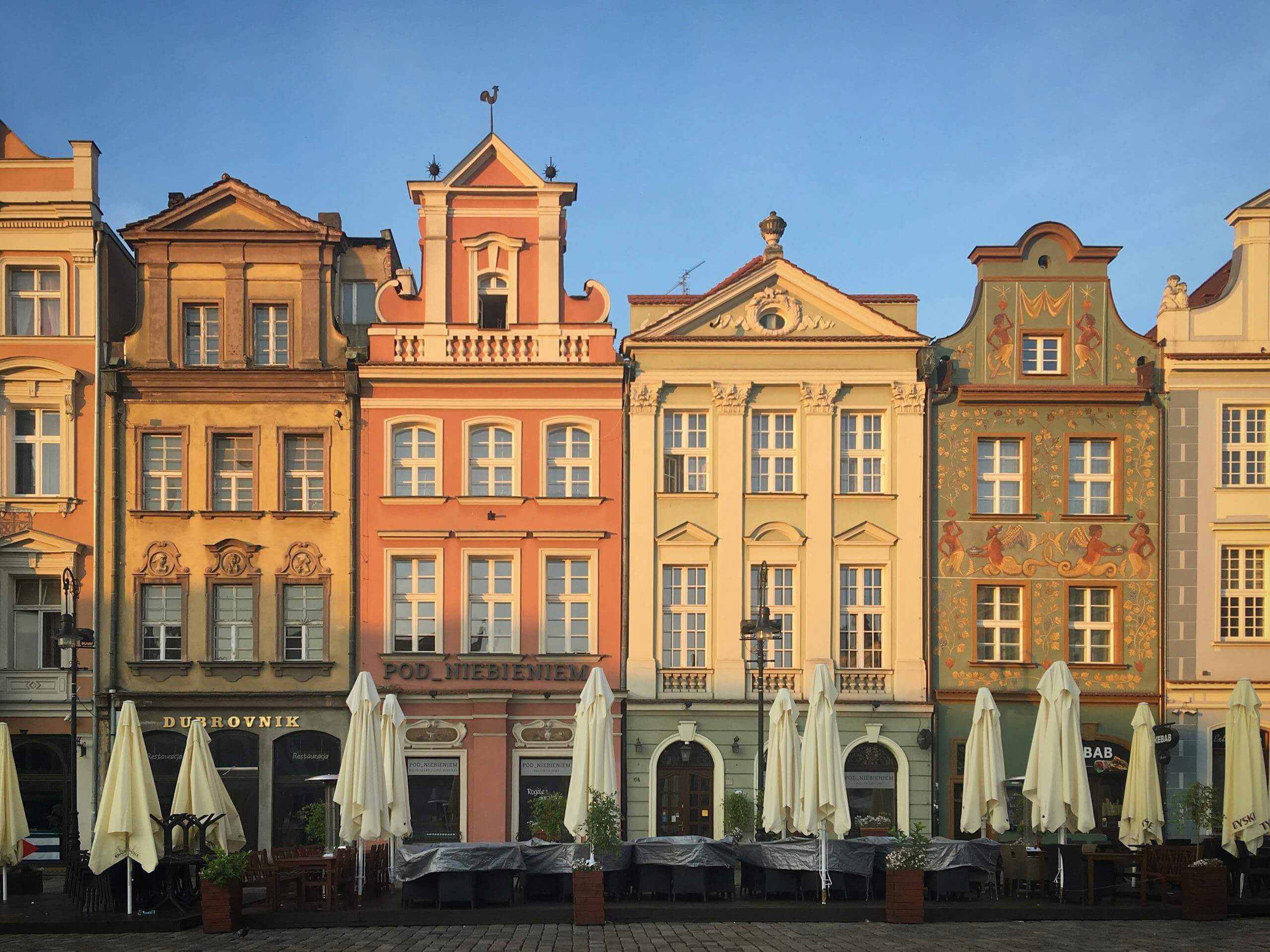 Charming colorful tenements in Poznań's Old Town Square, showcasing historic architecture.